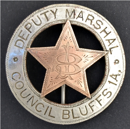 Council Bluffs, IA City Deputy Marshal badge, made of Coin silver with a 10k gold overlaid 5 point star with the letters J. B.  monogramed in the center.  T pin and C.catch.  Jeweler made.