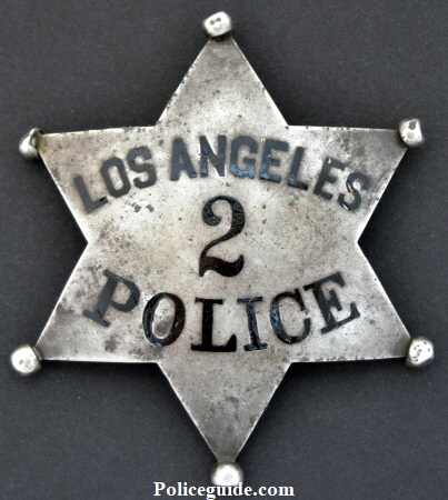 W.C. Roberts' LAPD Series 2 Police badge, made of sterling silver with hard fired black enamel.  Anker & Carson.