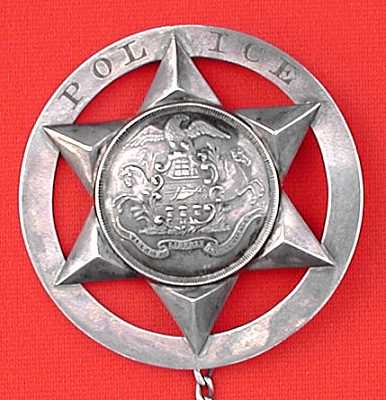 Police badge presented to Jacob Eriq.