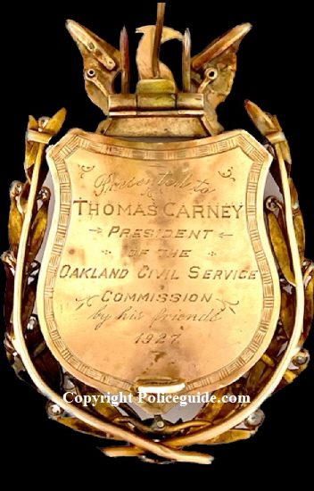 Back of badge showing presentation:  Presented to Thomas Carney - President of the Oakland Civil Service Commission - by his friends.  1927.