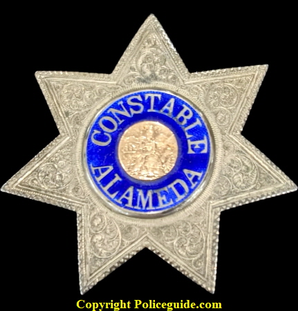 Constable Alameda (City of) sterling silver star with reverse blue enamel lettering and a karat gold center seal. Constable Alameda (City of) sterling silver star with reverse blue enamel lettering and a karat gold center seal.
