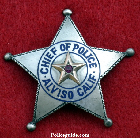 Chief Bacigalupi was not impressed with the badge and wanted one more fitting to his office.   Some time in 1921 he was presented with the sterling silver badge shown above right.  However, before the presentation was made the Mayor and friends of the Chief presented him with an enormous badge adorned with a bicycle refector in the center as a joke. See picture below.