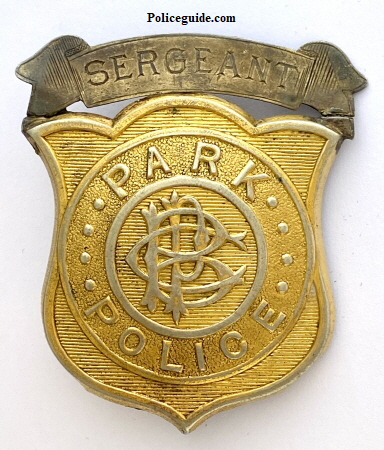 This Brooklyn Park Police Sergeants badge is an example of the badges worn by the officers patrolling the 526 acre Prospect Park. The park's police force was established in 1866. According to the Brooklyn Daily Eagle its mission was "to guard the property now on the ground, and hereafter promote the observance of the peace and respect for the improvements when the Park shall become a public resort."  The original force consisted of nine patrolmen, three sergeants, and a captain.  In the following photo from 195, patrolman John O'Hara warns Donald Boa of the dangers from skating on Prospect Park Lake.