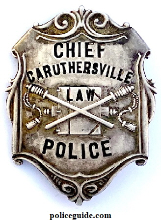 Caruthersville Chief Police badge, custom die with crossed police batons, the Roman Fasces and the Book of Law.  Made of sterling silver and hallmarked The Henderson Ames Co. Kalamazoo, Mich.