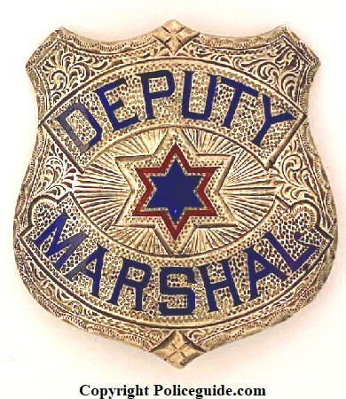 Deputy Marshal made in sterling, hand engraved with two colors of hard fired enamel.  Hallmarked J. C. Irvine