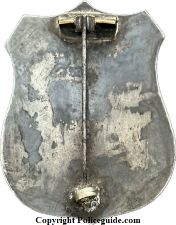 City Marshal Eureka shield, sterling silver, hand engraved, hard fired black enamel lettering.  The first City Marshal for Eureka was appointed in 1858.  On June 9, 1887 Ordinance 110 specifically designated the City Marshal as the ex-officio police chief.  In 1895 the title “City Marshal” was eliminated and the position of “Chief of Police” was created.