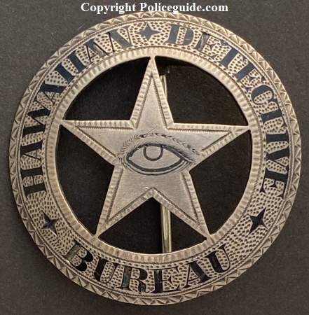 Hawaiian Detective Bureau.  Sterling silver with hard fired black enamel.