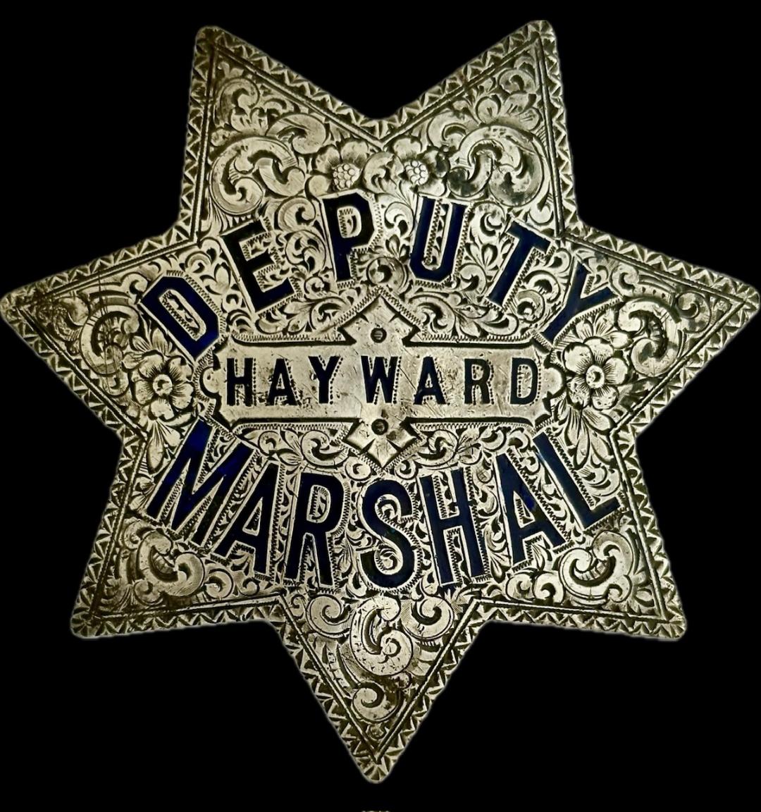 Hayward Deputy Marshal star made of sterling silver with hard fired blue enamel and beautifully engraved.  Made by California 835 Bdwy Oakland, CAL.