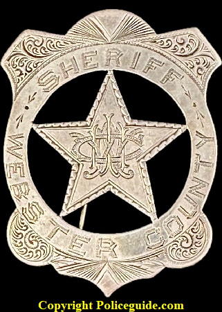 Sheriff Webster County IA shield, with monogram initials WWC in the center.  Made of sterling silver.  He was Sheriff 1894-1897.