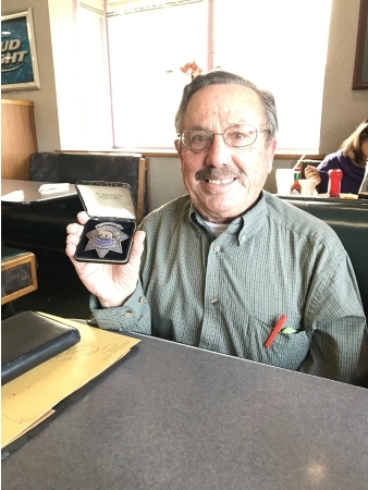 Claude Bisio's son happily reunited with his father's badge.