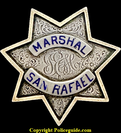 Personal badge of John E. Healy, the 1st City Marshal of San Rafael in 1893. Made by DWL S.F. JEH is engraved in the center, the badge is Sterling Silver with a 18k gold raised border. Healy was also the first Chief of Police when the title was changed from City Marshal. He was born in 1851 in New York and died January 22, 1920. In the San Rafael City Directory of 1901 he was still listed as Marshal. He was a brother of Frank Healy of Marin County a former Sheriff. Personal badge of John E. Healy, the 1st City Marshal of San Rafael in 1893. Made by DWL S.F. JEH is engraved in the center, the badge is Sterling Silver with a 18k gold raised border. Healy was also the first Chief of Police when the title was changed from City Marshal. He was born in 1851 in New York and died January 22, 1920. In the San Rafael City Directory of 1901 he was still listed as Marshal. He was a brother of Frank Healy of Marin County a former Sheriff.