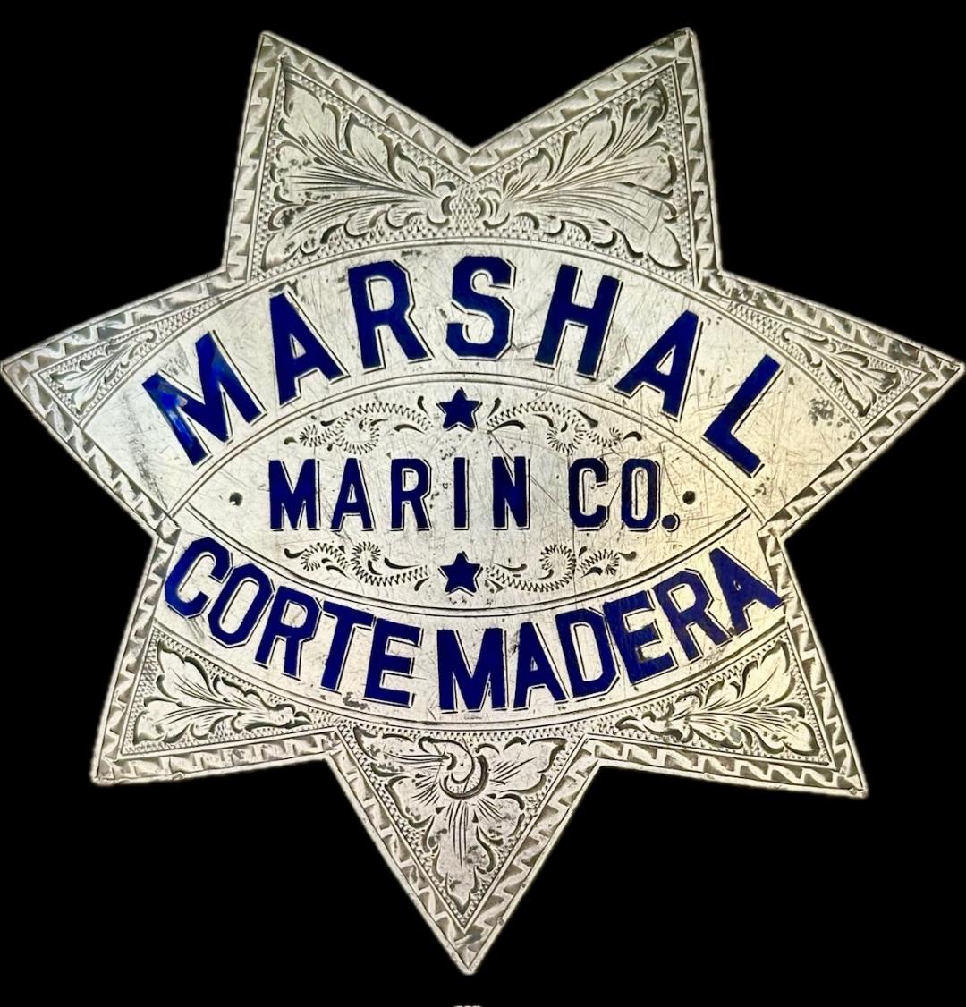 Marshal Corte Madera Marin Co.and worn by William A. Wyatt who also owned a Fruit and Vegetable business in Corte Madera.  The star is made of sterling silver with hard fired blue enameled lettering and nicely hand engraved.  Hallmarked Irvine & Jachens 1027 Market St. and dated 7-14-24.  