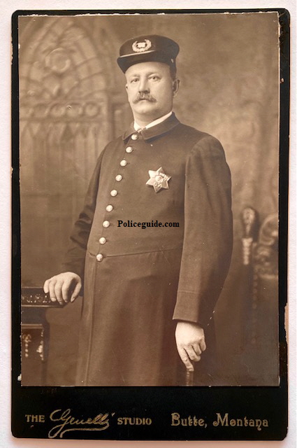 Butte, Montana cabinet card image of 1906 era police officer wearing badge #62.  Back of image has name Bill Yoroth written on it.