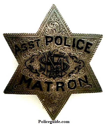 Assistant Matron badge presented to Mrs. M. L. Sanders by Friends in the Police Department July 1912.  Badge is sterling silver, hand engraved and has her initials monogramed in the center.