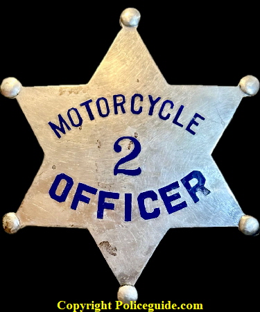 Motorcycle Officer No. 2, sterling silver with hard fired blue enamel.  Thought to be Stockton, CA police department, circa 1915.