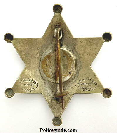 Back of Norfolk Nebraska Police badge No. 22 made by J. P. Cooke Co. Mfg’s Omaha, NEB.