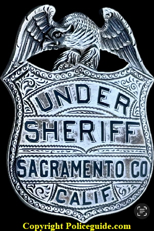 Sacramento Co. Undersheriff shield made of sterling silver with hard fired enamel lettering and hand engraved, worn by Thomas M. Ryan who was appointed in  1916.  The shield was donated by Mrs. Thomas M. Ryan in 1966 to Jack Bright who served as a Napa, CA Policeman.