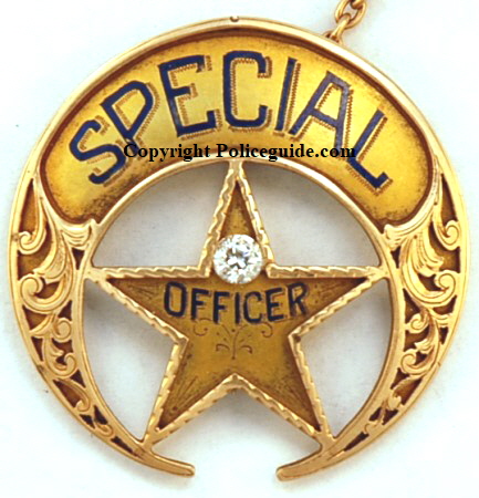 New Orleans Special Police  badge, circa 1920, 14k gold, adorned with a diamond, with hard fired blue enamel lettering and hand engraved gold inlay designs.