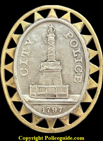 Baltimore Police 3rd issue Type 1, the original construction with two pieces, a silver colored center seal  soldered to a brass 20 point ringed outer border..  In use from 1862 to 1890.  During this period the Type 2 was introduced which was cheaper to made with one piece construction all of the same silver colored metal.