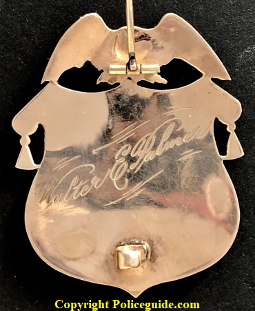 1k gold Baker Oregon Chief of Police badge presented to Walter E. Palmer.