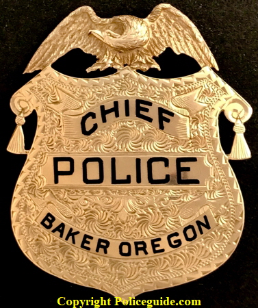 1k gold Baker Oregon Chief of Police badge presented to Walter E. Palmer.