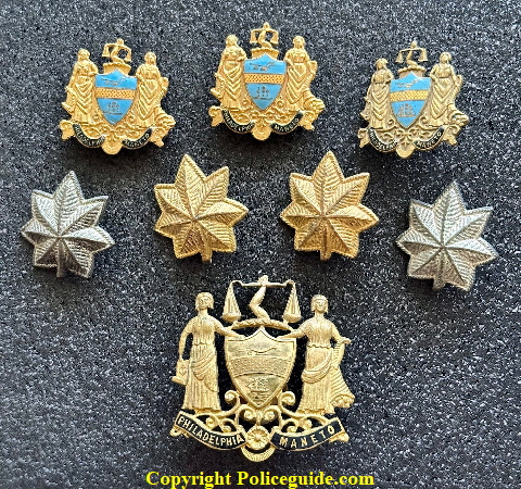 Caleb J. Brinton�s various collar insignia and his cap device.