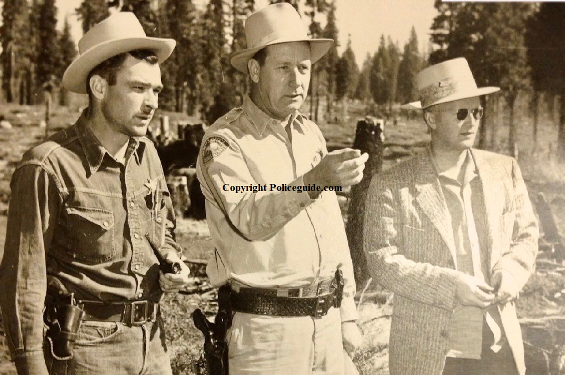 Pictured on the left is Abby Abernethy, center is Sheriff Melvin H. Schoole, the man on the right is unknown.  Circa 1948.