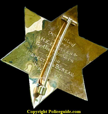 Back of Captain of inspectors badge showing presentation: Presented to H. E. E. Green By the Members of the Inspectors bureau Sept. 1st, 1917