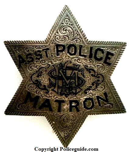Assistant Matron badge presented to Mrs. M. L. Sanders by Friends in the Police Department July 1912.  Badge is sterling silver, hand engraved and has her initials monogramed in the center.