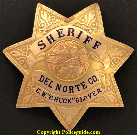 Gold front presentation badge to Del Norte Sheriff Glover.