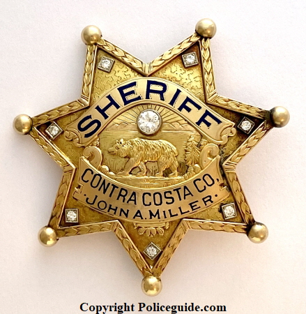 14k gold badge presented to newly elected Sheriff John A. Miller May 19, 1935.  He was in office 1935-1943.   Hallmarked Jones 14k.