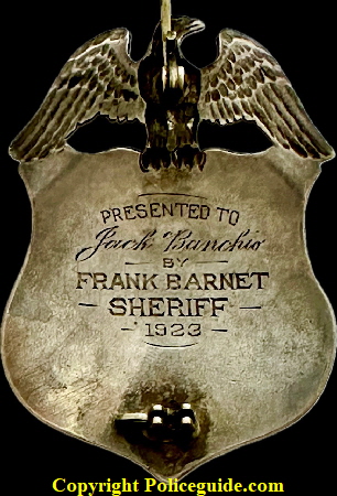 Back of Alameda Co. Deputy Sheriff eagle top shield, Presented to Jack Banchio by Frank Barnet Sheriff 1923.  Sterling silver with hard fired blue enamel