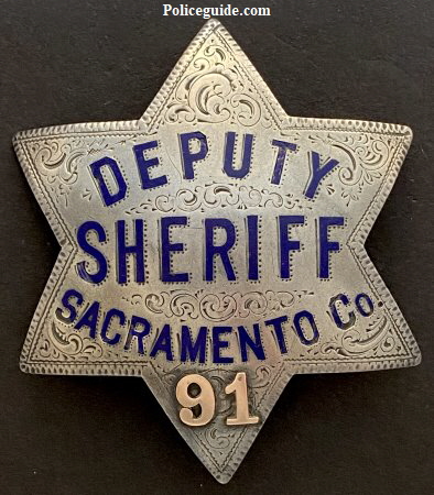 Sacramento County Deputy Sheriff badge #91. Made of sterling silver, hand engraved, hard fired blue enamel with applied gold numbers.
