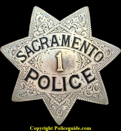 Sacramento Police star No. 1, made of sterling silver and having an applied gold numeral placed in the center, surrounded by hand engraving and hard fired black enamel lettering. Hallmarked Ed Jones Co. Oakland, CAL Sacramento Police star No. 1, made of sterling silver and having an applied gold numeral placed in the center, surrounded by hand engraving and hard fired black enamel lettering. Hallmarked Ed Jones Co. Oakland, CAL