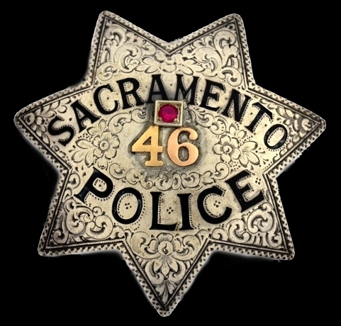 Sacramento Police badge No. 46 in gold numbers and adorned with a Ruby.  This was a badge that could be ordered through the department by the officers wife to be presented as a Christmas or Birthday gift.  Circa 1922, made by Ed Jones Oakland, CAL.