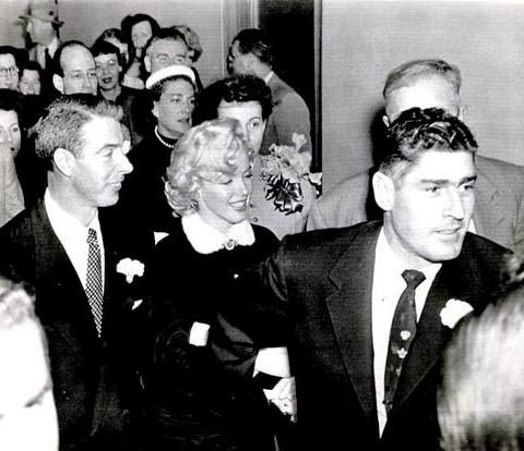 Reno Barsocchini leading newlyweds Marilyn Monroe and Joe DiMaggio as they left the wedding ceremony.