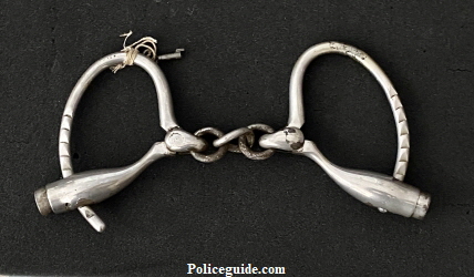 Henry Gaylord�s nickel plated handcuffs hallmarked Marlin Firearms Company, with key.