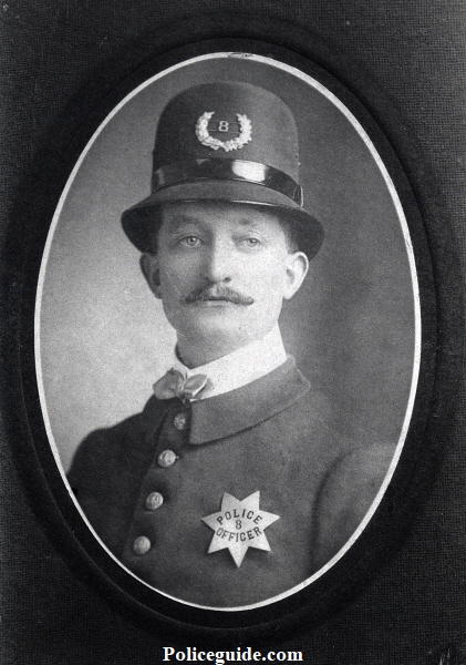 Photo of a young John N. Black wearing San Jose Police badge No. 8 pie plate.