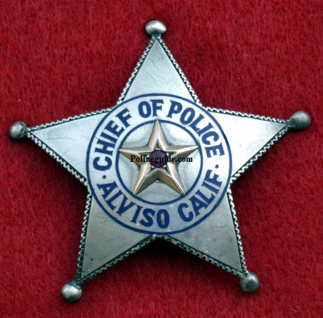 Chief Bacigalupi was not impressed with the badge and wanted one more fitting to his office.   Some time in 1921 he was presented with the sterling silver badge shown above right.  However, before the presentation was made the Mayor and friends of the Chief presented him with an enormous badge adorned with a bicycle refector in the center as a joke. See picture below.