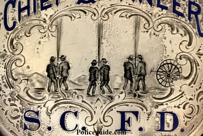 Close up of engraved scene.