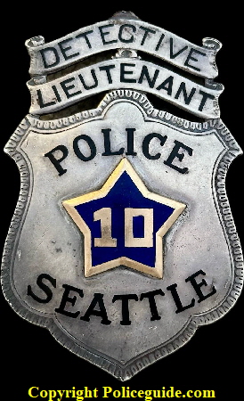    Seattle Police Detective Lieutenant No. 10 with 14k gold numbers in a blue enamel inside a 14k gold star, presented to V. L. Webb,  made of sterling silver with hard fired black enameled lettering.