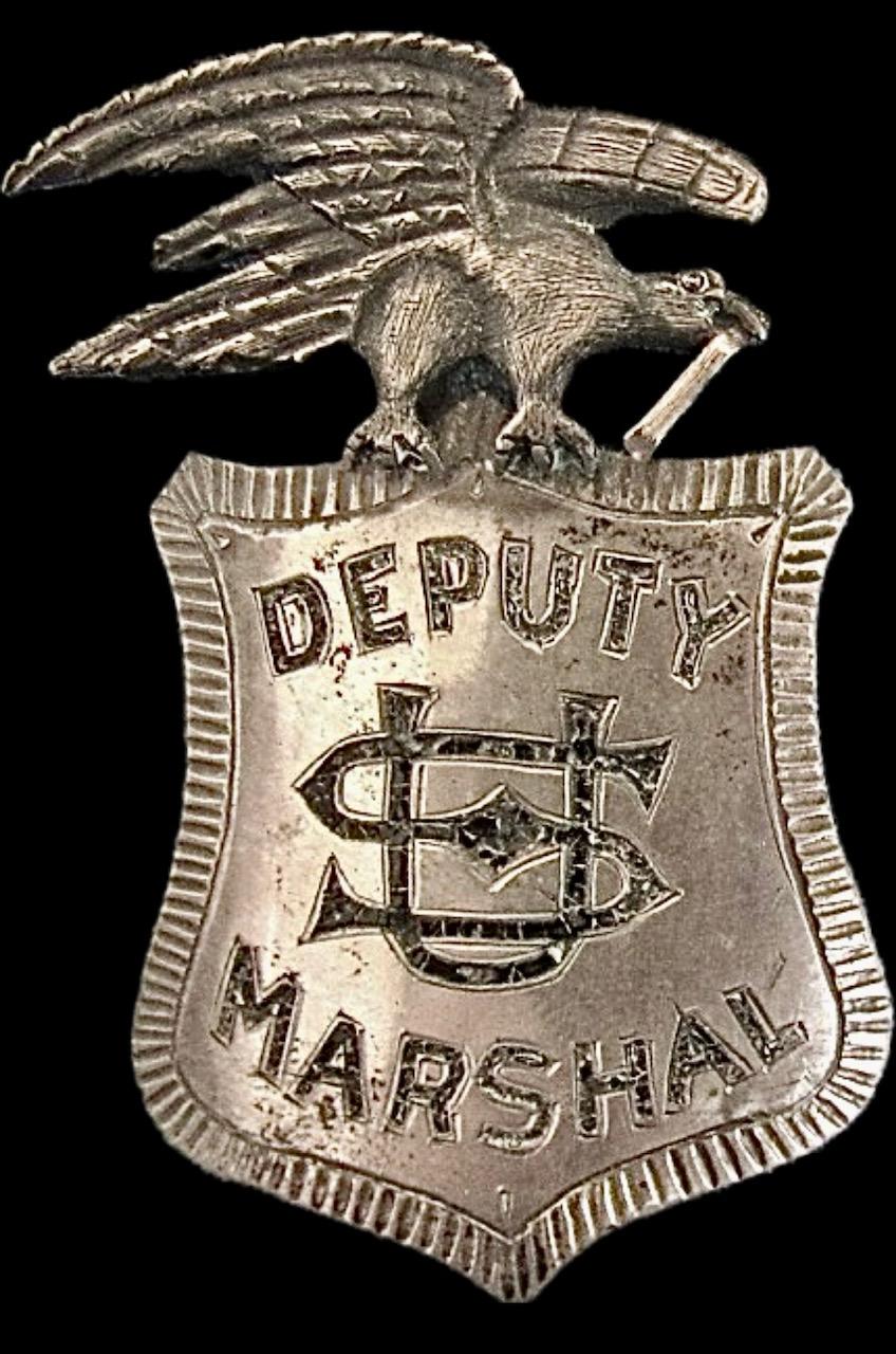 U. S. Deputy Marshal from Texas, made of sterling silver with a 14k gold scroll in the beak of the eagle.  T-pin on back, maker unknown.