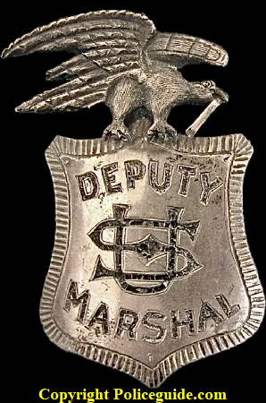 U. S. Deputy Marshal from Texas, made of sterling silver with a 14k gold scroll in the beak of the eagle.  T-pin on back, maker unknown.