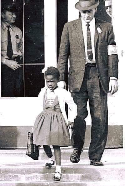 U.S. Marshalls escorting the extremely brave Ruby Bridges, 6 years old, to school in 1960. This courageous young girl is known for being the first African American child to attend an all-white elementary school in the South