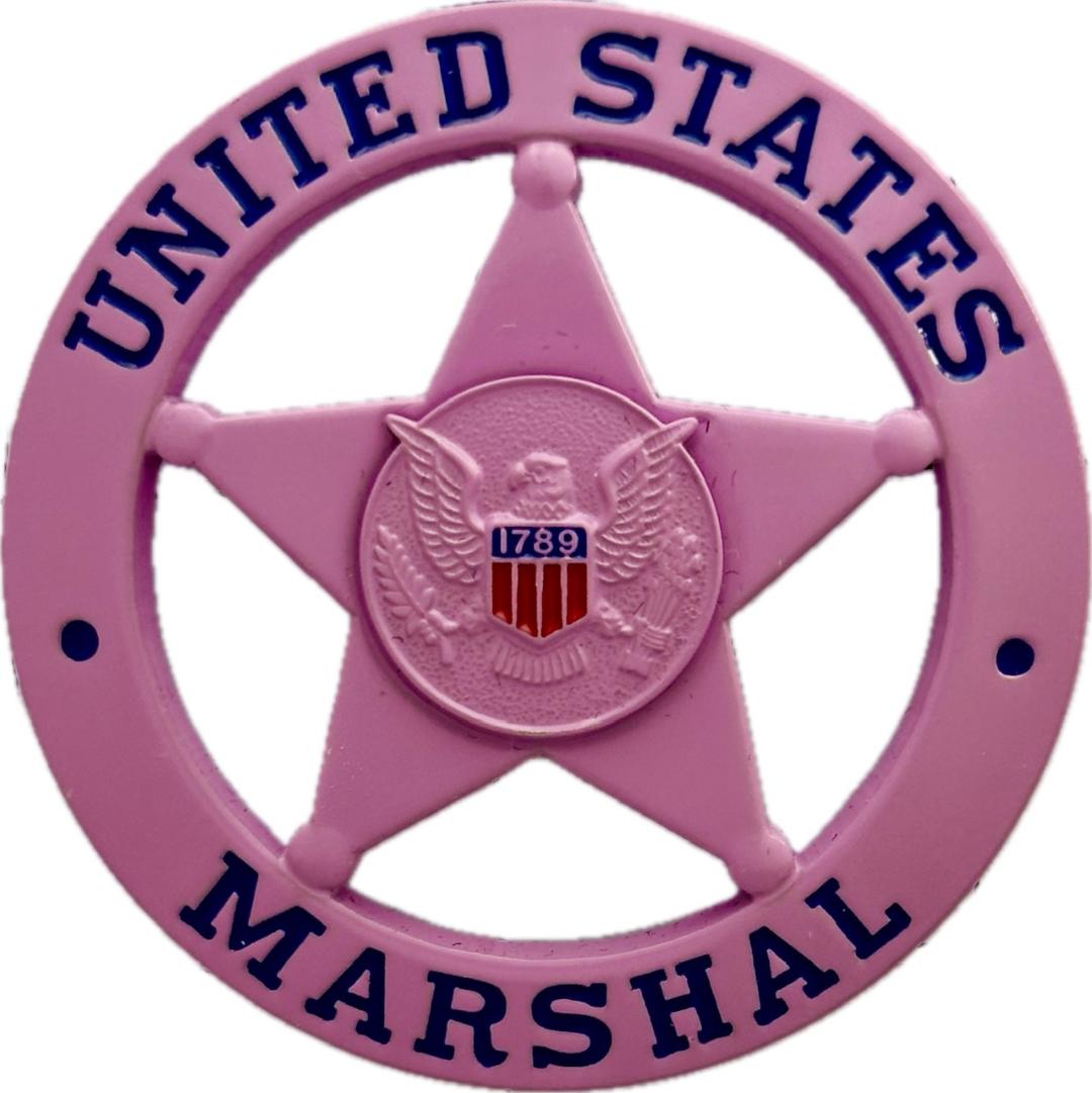 United States Marshal circle star badge in pink.  Personal badge of Uncle Budd Johnson who rose to the rank of Inspector with the Marshals Service.  He was well known as an expert on Outlaw Biker Gangs and provided training for law enforcement agencies in the U.S.A., Canada and the United Kingdom.  He has been featured in T.V. documentaries and mentioned in numerous books on the U. S. Marshals.  R.I.P.