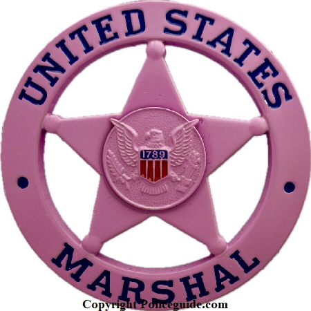 United States Marshal circle star badge in pink.  Personal badge of Uncle Budd Johnson who rose to the rank of Inspector with the Marshals Service.  He was well known as an expert on Outlaw Biker Gangs and provided training for law enforcement agencies in the U.S.A., Canada and the United Kingdom.  He has been featured in T.V. documentaries and mentioned in numerous books on the U. S. Marshals.  R.I.P.