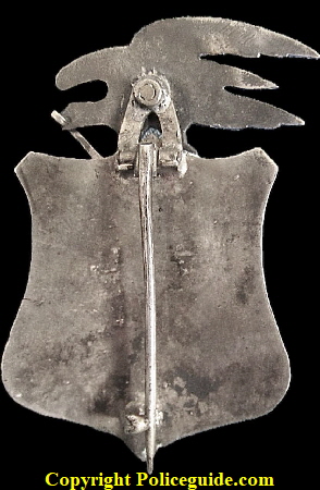 U. S. Deputy Marshal from Texas, made of sterling silver with a 14k gold scroll in the beak of the eagle.  T-pin on back, maker unknown.